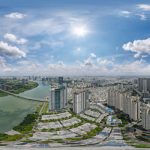 Ảnh flycam 360 toàn cảnh khu đô thị ven sông với các tòa cao tầng, cầu và mảng xanh xung quanh
